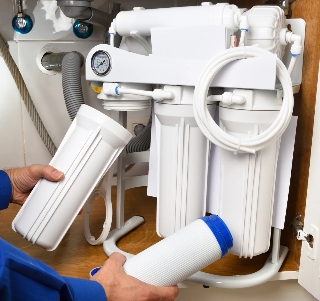 Person replacing water filter components