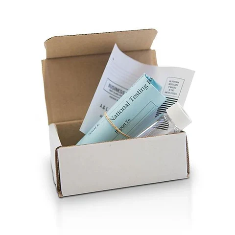 Home medical test kit in open cardboard box